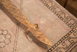 Detail of vintage iron lizard sculpture head, showing rustic texture and aged patina.