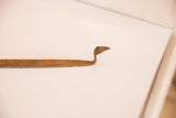 Curved head of the vintage iron snake sculpture, showing its rich, textured patina.
