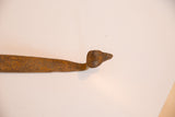 Close-up of the vintage iron snake sculpture head, featuring its rich rusted patina.