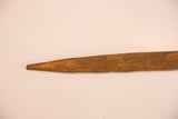 Pointed tail detail of vintage iron snake sculpture, showing its rich, textured rust.