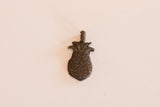 Reverse side of the vintage bronze pineapple pendant showing its textured patina.