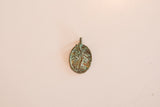 Vintage bronze Tree of Life pendant detail, highlighting intricate design and green patina.