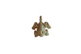 Vintage African bronze pendant of a winged frog with a textured surface and green patina.
