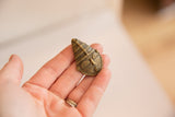 A small vintage bronze face sculpture showing its collectible scale and detailed casting.