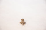 African bronze frog pendant, displaying its textured back and dusty patina.
