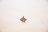 African bronze frog pendant from above, highlighting its aged back and dusty patina.