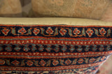 Vintage Persian pillow edge detail: hand-knotted red, blue, teal floral borders.