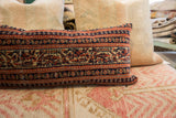Hand-knotted vintage Persian rug fragment pillow with intricate tribal blue and red pattern.