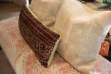 Textured light beige back of the pillow, with a corner 'LAB. SAMPLE' tag.