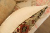 Textured early 20th-century Mir Serbend rug fragment pillow edge with muted red and beige patterns.