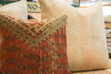 Detailed view of the red vintage Mir Serbend rug fragment pillow's aged texture and geometric motifs.