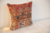 Hand-knotted antique Malayer pillow corner featuring rich red, blue, beige geometric motifs.