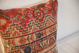 Geometric stepped patterns and hand-knotted texture on this antique Malayer rug fragment pillow.