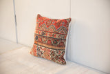 Hand-knotted texture and geometric patterns on this vintage Malayer rug pillow corner.