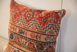 Textured hand-knotted red, blue, and tan geometric patterns of the vintage Malayer pillow.