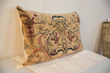 Side profile of the oversized antique Persian Kerman rug fragment pillow, showing cream backing and dark blue and red patterns.