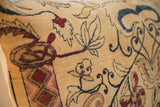 Beige ground antique Kerman pillow detail with ruby and dark blue mythological motifs.