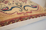 Oversized Kerman rug fragment pillow side, showcasing red and blue mythology motifs.