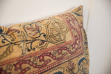 Angled detail of the antique Kerman pillow's hand-knotted texture and intricate mythological motifs in saffron and ruby.