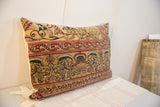 Corner view antique Persian Kerman rug pillow, gold, red, indigo mythological motifs.