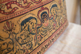 Textured detail of the vintage Kerman rug pillow's golden, red, and blue hand-knotted floral pattern.
