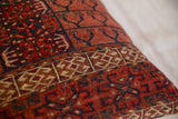 Detailed view of antique Turkmen pillow's hand-knotted pile and tribal geometric motifs.