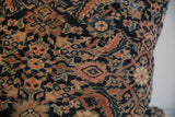 Detail of hand-knotted antique Persian Fereghan pillow with navy, rust, green, and gold motifs.
