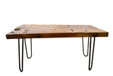 Reclaimed wood coffee table with rustic textured brown top and black hairpin legs.