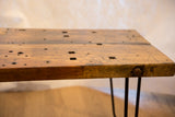 Reclaimed wood coffee table, rustic textured top, thick edge, and hairpin leg bolt.