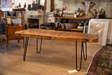 Thick, textured reclaimed wood coffee table top with black hairpin legs.