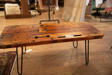 Reclaimed vintage wood coffee table side showing thick lumber and exposed bolts.