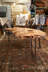 Expressive natural live edge wood table top with rich texture.