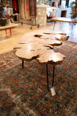 Expressive live edge wood coffee table, showing black hairpin leg and SKU tag.