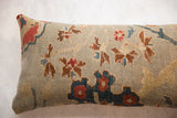 Floral vinery motif on antique Persian Sultanabad rug fragment pillow, seafoam, red, and blue.