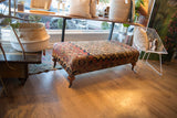 Antique Persian Rug Ottoman Coffee Table with ruby red, blue, beige Khorassan Doroksh pattern.
