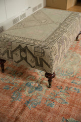 Turned mahogany finished leg with a functional brass caster on the vintage rug ottoman.