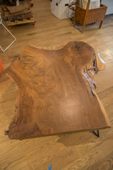 Walnut coffee table top featuring natural live edge, swirling grain, and rich brown tones.