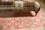 Vintage Oushak rug ottoman with geometric brown, ivory pattern and curved wooden leg, brass caster.