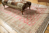 Vintage Oushak rug fragment border, muted floral pattern in brown, ivory, and hints of pink.