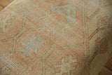Textured pile of vintage Turkish Oushak rug fragment, soft pale yellow, pink, muted blue.