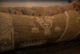 Textured pile with muted tones and faded patterns of the vintage Turkish rug fragment pillow.