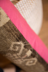 Textured brown Oushak rug fragment with subtle pattern and smooth pink backing.