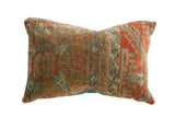 Hand-knotted Antique Belouch fragment pillow, rich terracotta, tan, and blue geometric patterns.