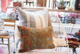 Antique Belouch rug fragment pillow displaying aged geometric patterns and warm, earthy colors.