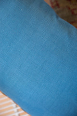 Solid blue woven fabric backing for the antique Belouch fragment pillow.