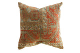 Handmade antique Belouch rug fragment pillow with geometric patterns in rust, tan, and blue.