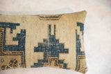 Textured weave and distressed blue geometric motifs on vintage Caucasian rug pillow.