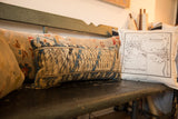 Blue and beige geometric pattern on a distressed handmade vintage Caucasian rug lumbar pillow.
