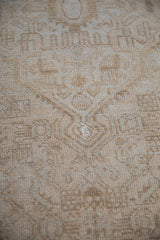 Distressed vintage Persian rug fragment pile in neutral colors, showing foundation.