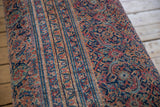 Vintage Persian rug ottoman fragment: navy, faded red, gold striped and curvilinear patterns.